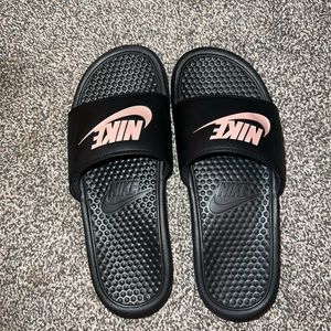 Pink and black Nike slides